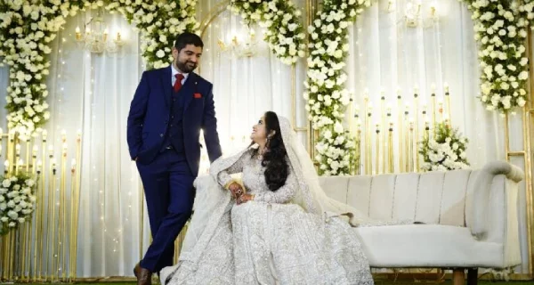 A couple gazing at each other on their Muslim wedding day, beautifully captured by Sidphoto.