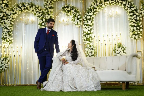 A couple gazing at each other on their Muslim wedding day, beautifully captured by Sidphoto.